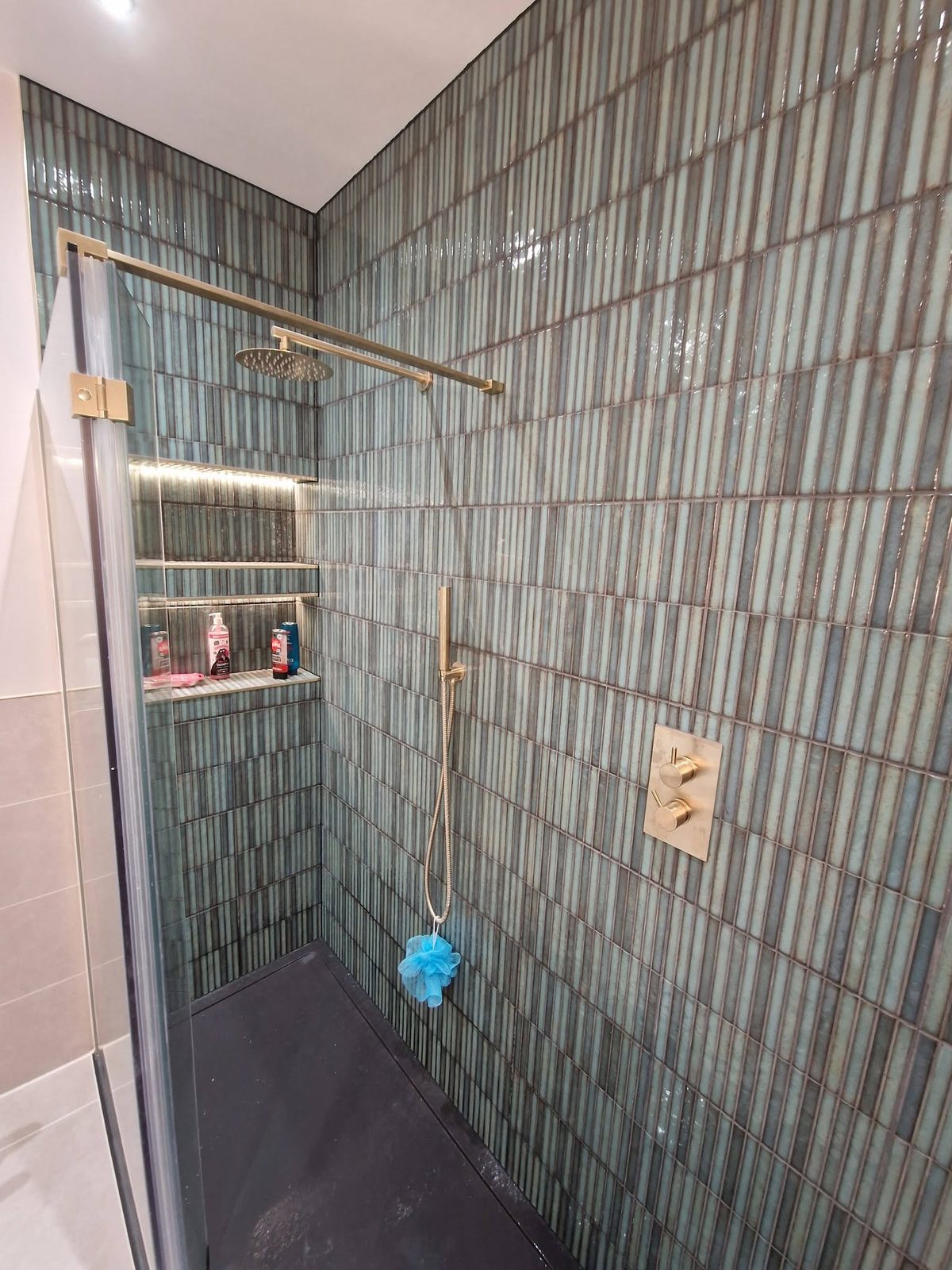 Walk-in shower with a lit niche and brass fittings, Ashburys Property Renovations, Stockport