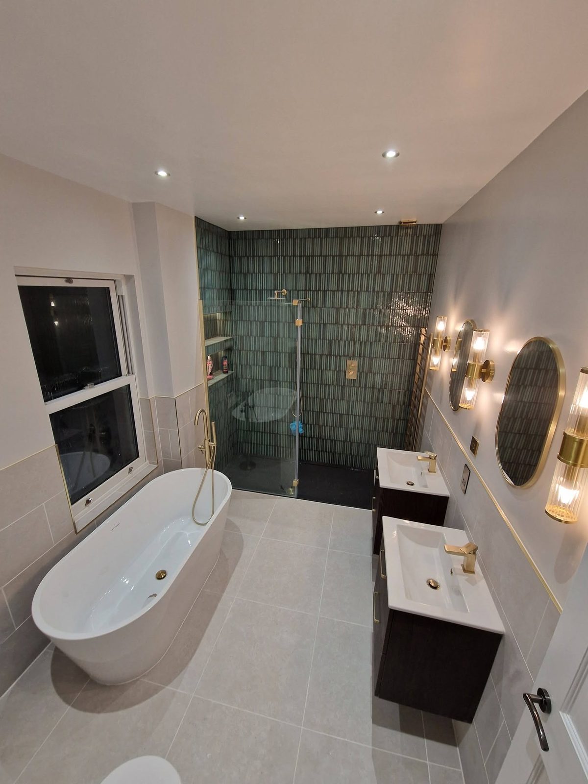 After: freestanding bath, walk-in shower with green tiles and brass fittings
