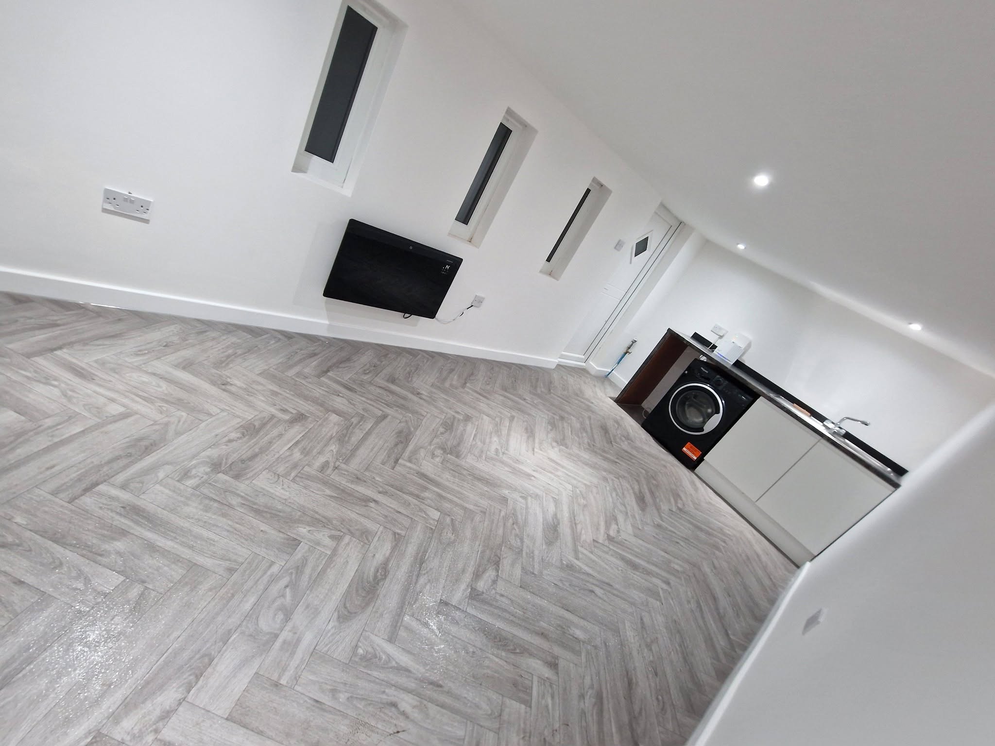 Finished conversion with herringbone flooring and a kitchenette, Ashburys Property Renovations, Stockport