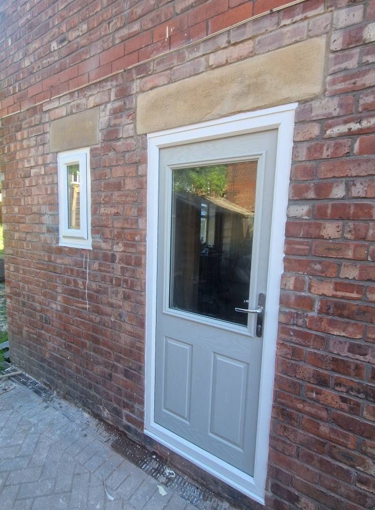 New composite rear door set under a stone lintel, Ashburys Property Renovations, Stockport