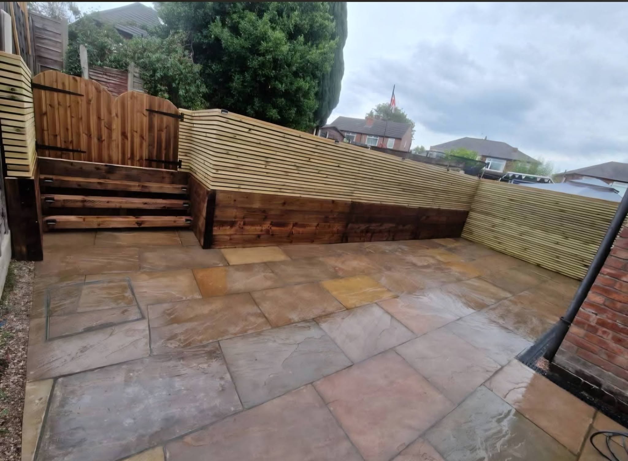 Indian stone patio with sleeper retaining wall and new fencing, Ashburys Property Renovations, Stockport